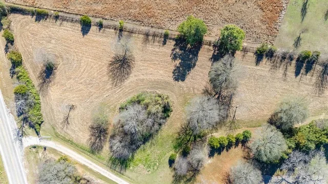 an aerial view of a house with a mountain