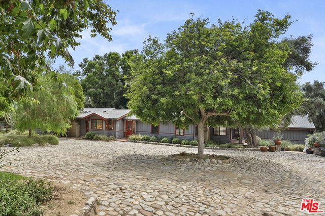 a kitchen with stainless steel appliances cabinets and a window