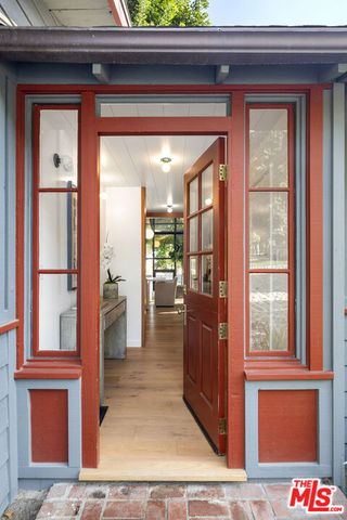 a kitchen with a sink and wooden floor