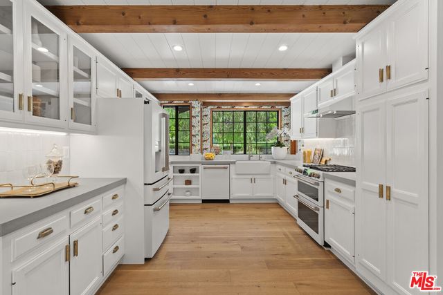 an aerial view of a house with a yard and lake view