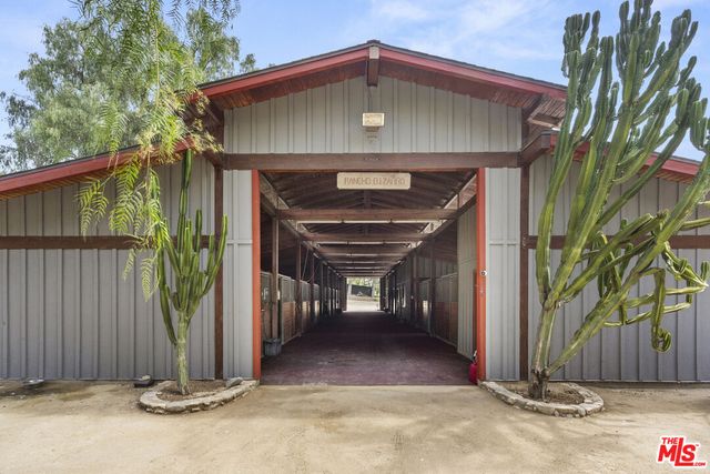 a view of a bench with wooden fence