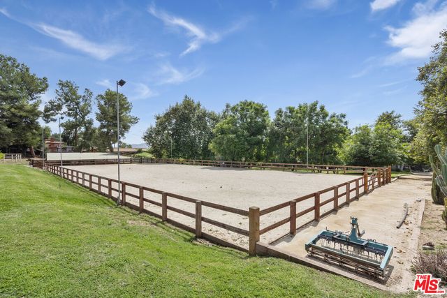 a view of a hallway with wooden floor and windows