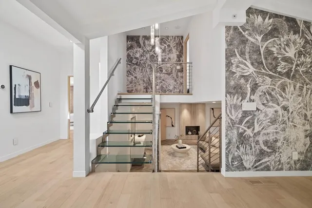 a view of a livingroom with wooden floor and stairs