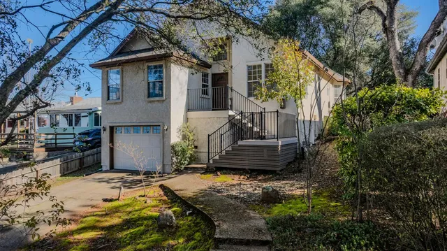 a view of a house with a bed and wooden fence