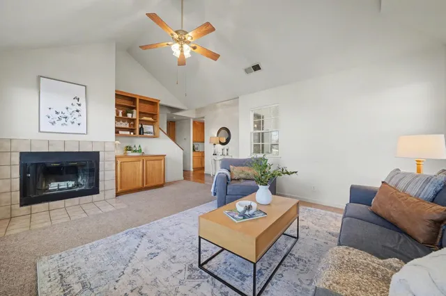 a living room with furniture a fireplace and a flat screen tv