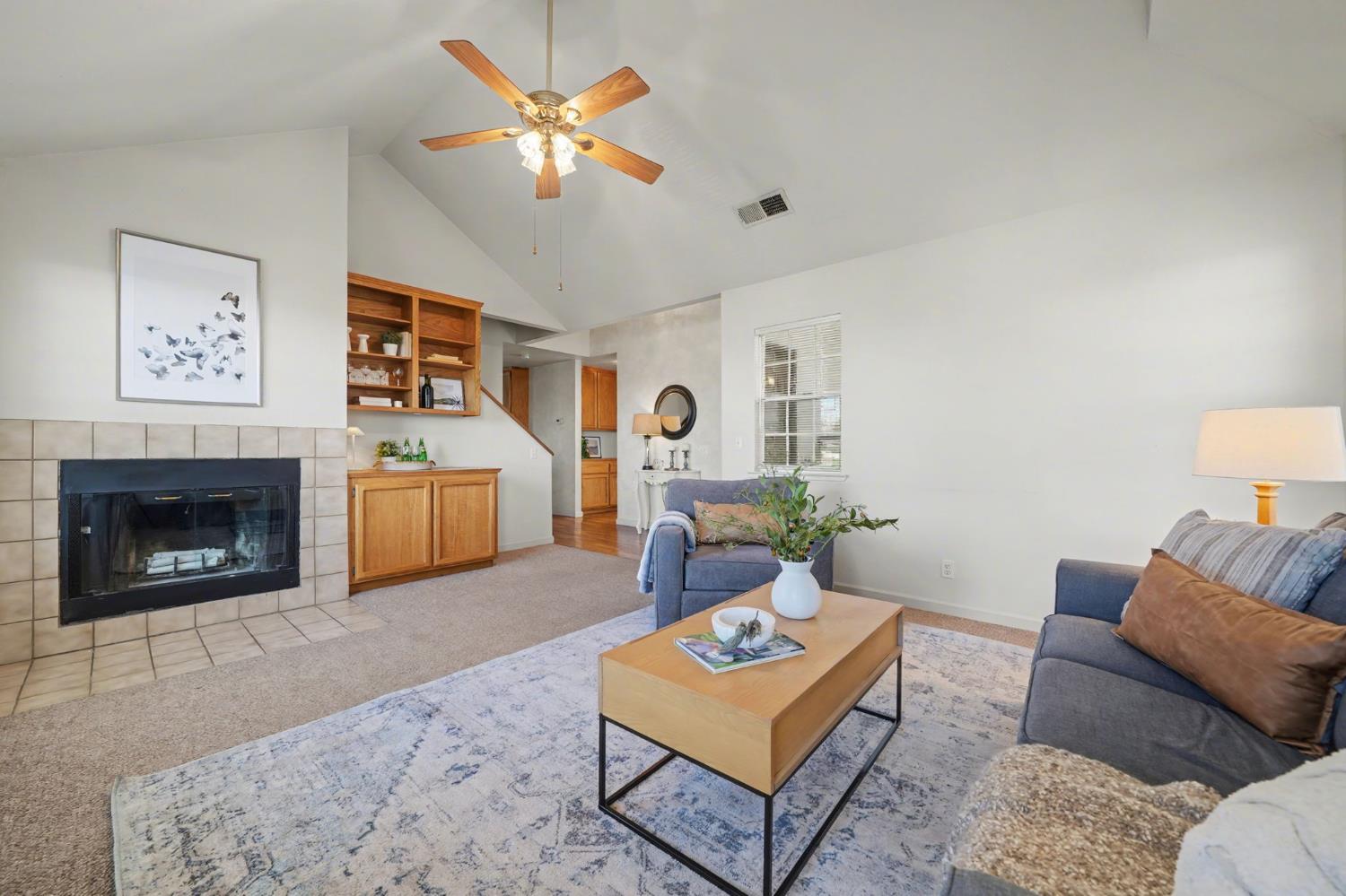238 Highland Drive Sutter Creek, CA 95685 - Photo 19 of 52 a living room with furniture a fireplace and a flat screen tv