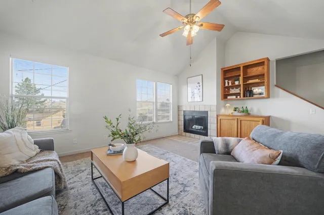 a living room with furniture a chandelier and a fireplace