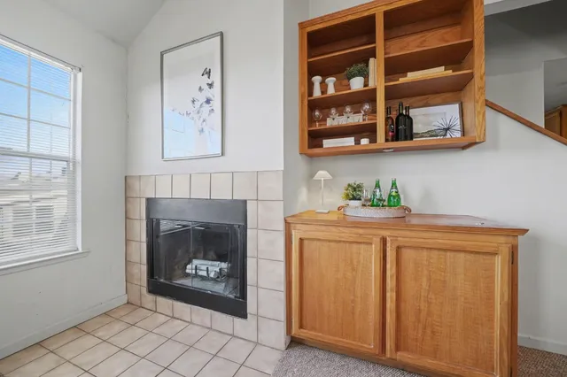 a hallway with cabinets and a fireplace