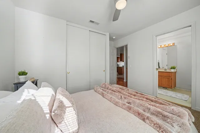 a bedroom with a bed and a mirror