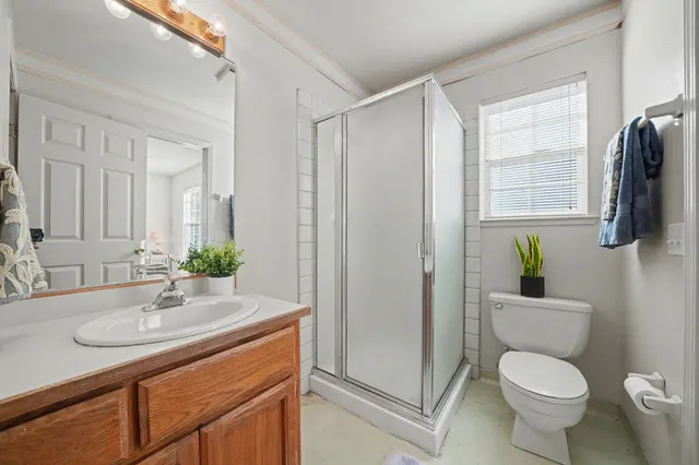 a bathroom with a sink toilet and shower