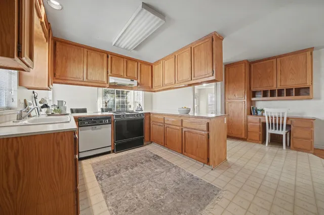 a kitchen with a sink a counter top space and cabinets