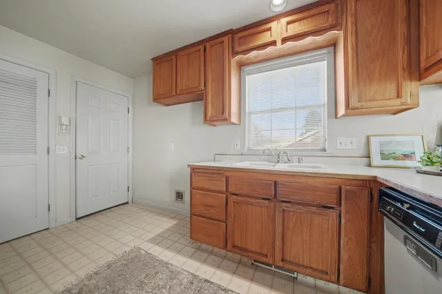 a spacious bathroom with a granite countertop sink and a mirror