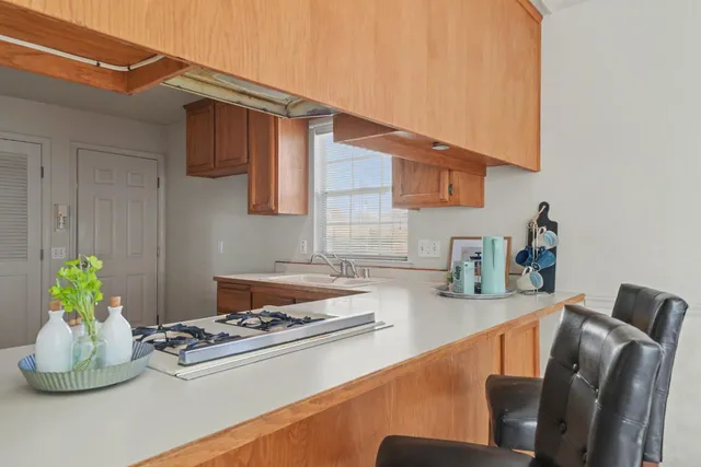 a kitchen with stainless steel appliances granite countertop a sink and a stove