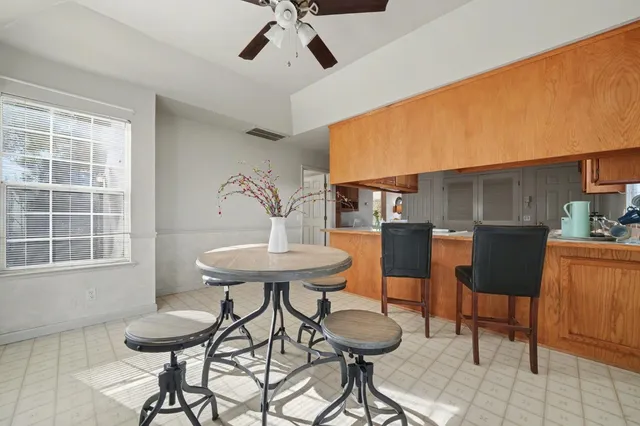a view of a dining room with furniture and a window