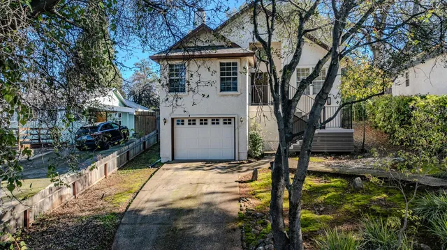 a front view of a house with garden