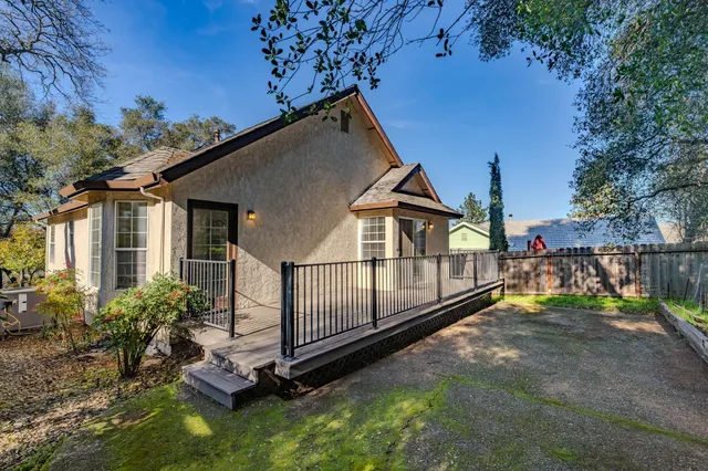 a view of a house with a yard porch and furniture