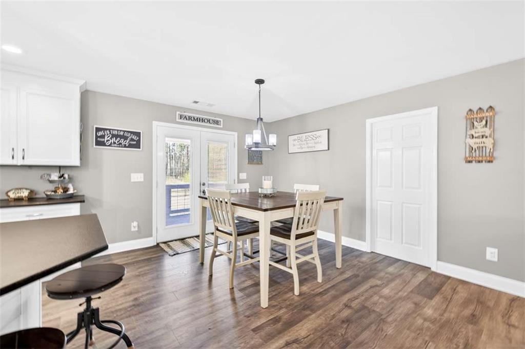 2361 County Line Road Mansfield, GA 30055 - Photo 19 of 57 a view of a dining room with furniture window and wooden floor