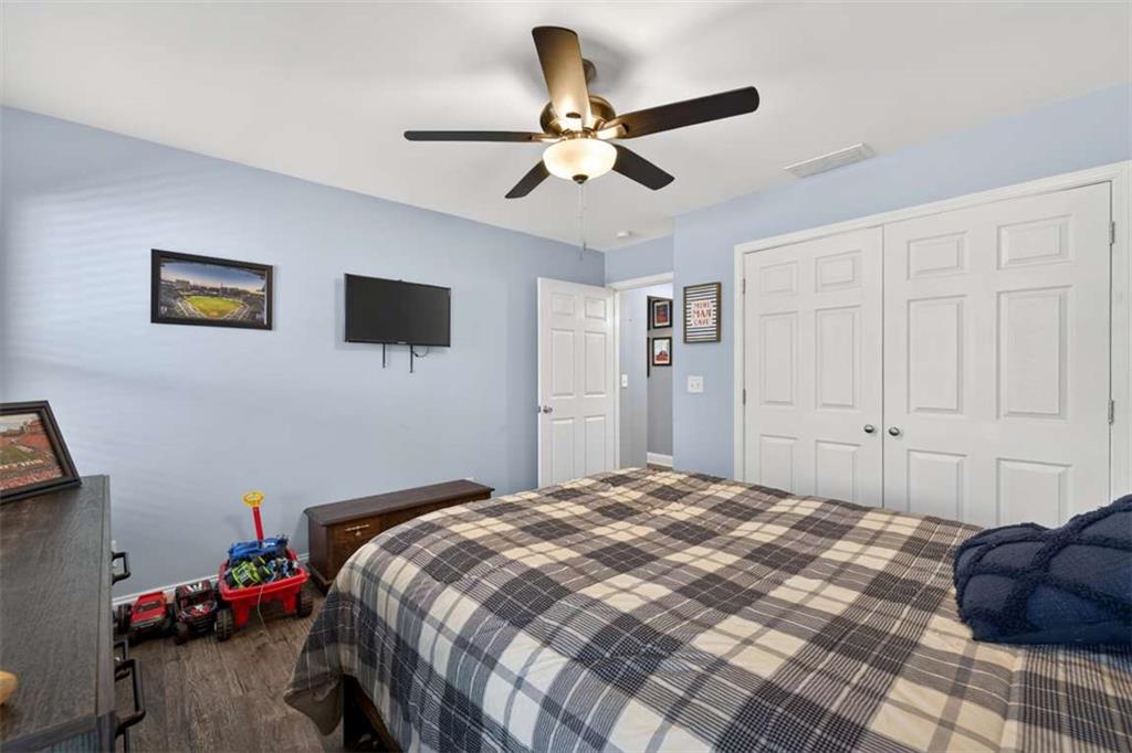 2361 County Line Road Mansfield, GA 30055 - Photo 25 of 57 a bedroom that has a bed and a chandelier