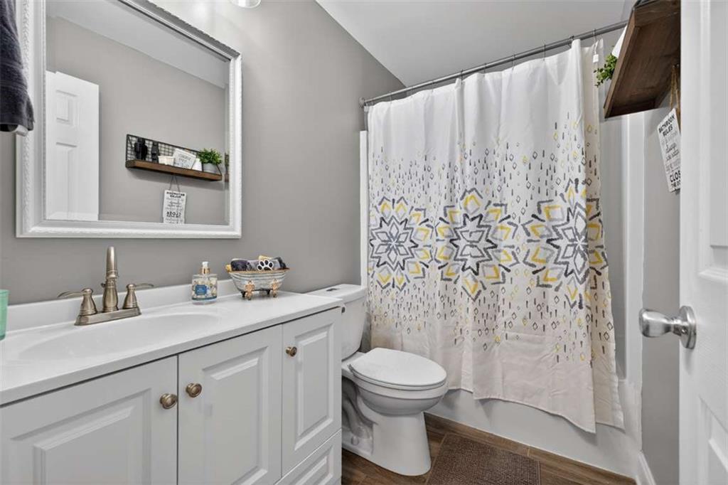 2361 County Line Road Mansfield, GA 30055 - Photo 27 of 57 a bathroom with a toilet sink and mirror