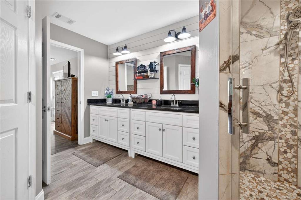 2361 County Line Road Mansfield, GA 30055 - Photo 39 of 57 a spacious bathroom with a double vanity sink and a mirror