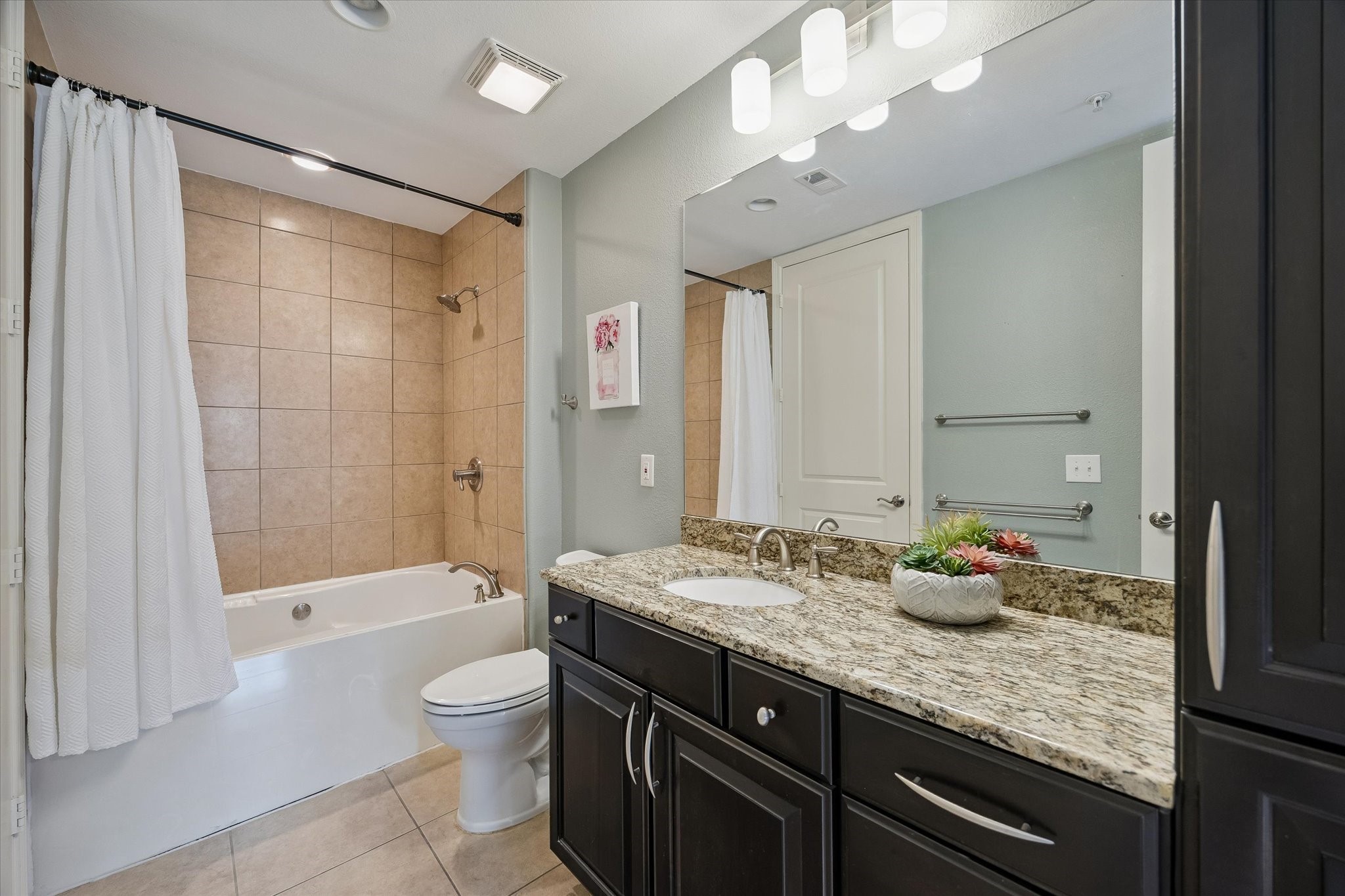 2120 Kipling Street, Unit 304 Houston, TX 77098 - Photo 18 of 24 Clean finishes and a functional layout make the guest bath a comfortable extension of the home’s thoughtful design. Convenient access from the guest suite adds extra privacy and flexibility.