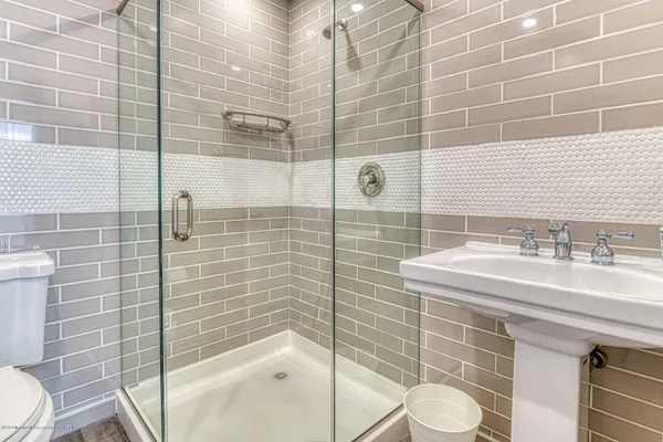 a bathroom with a sink toilet and shower
