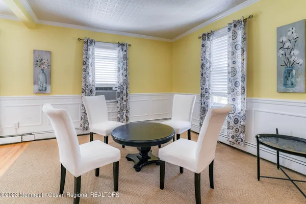 a view of a dining room with furniture and a window