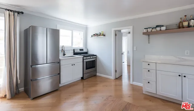 a kitchen with stainless steel appliances a refrigerator sink and cabinets