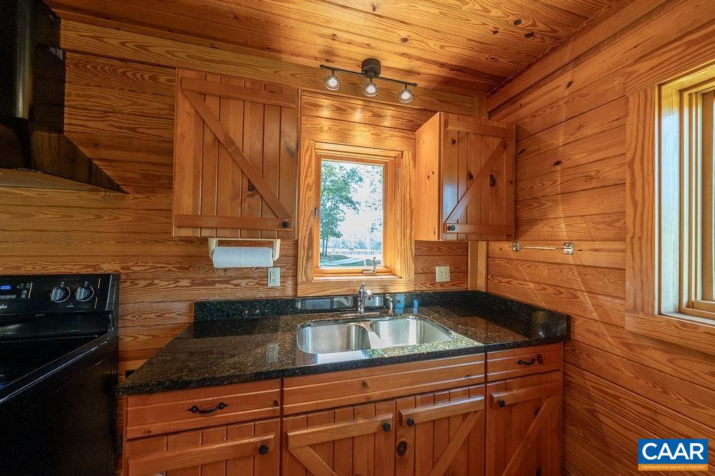 6033 Amicus Road Ruckersville, VA 22968 - Photo 15 of 74 a kitchen with granite countertop a sink and a stove