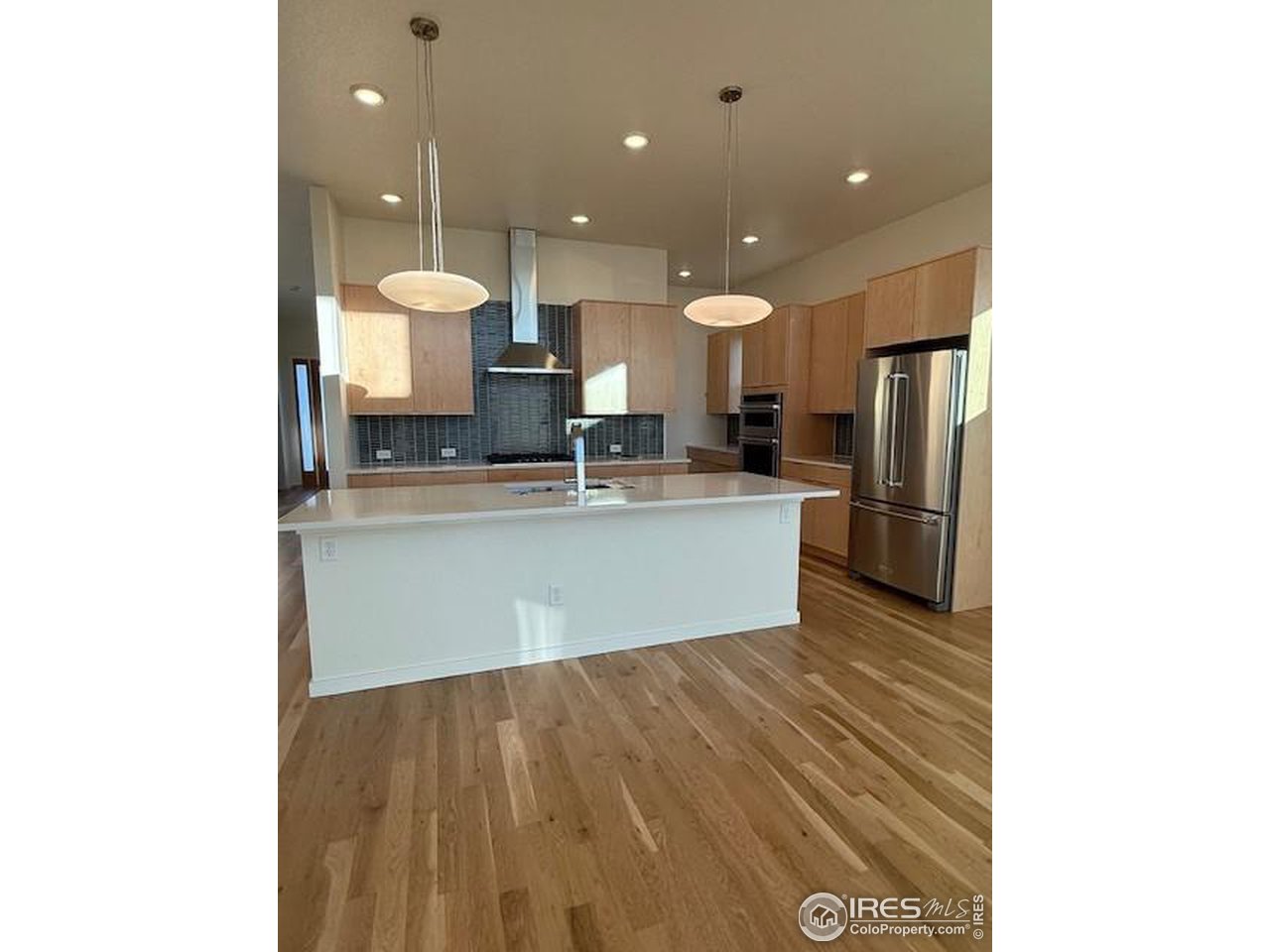 607 Mountain Drive Longmont, CO 80503 - Photo 4 of 18 a kitchen with kitchen island a sink and a stove