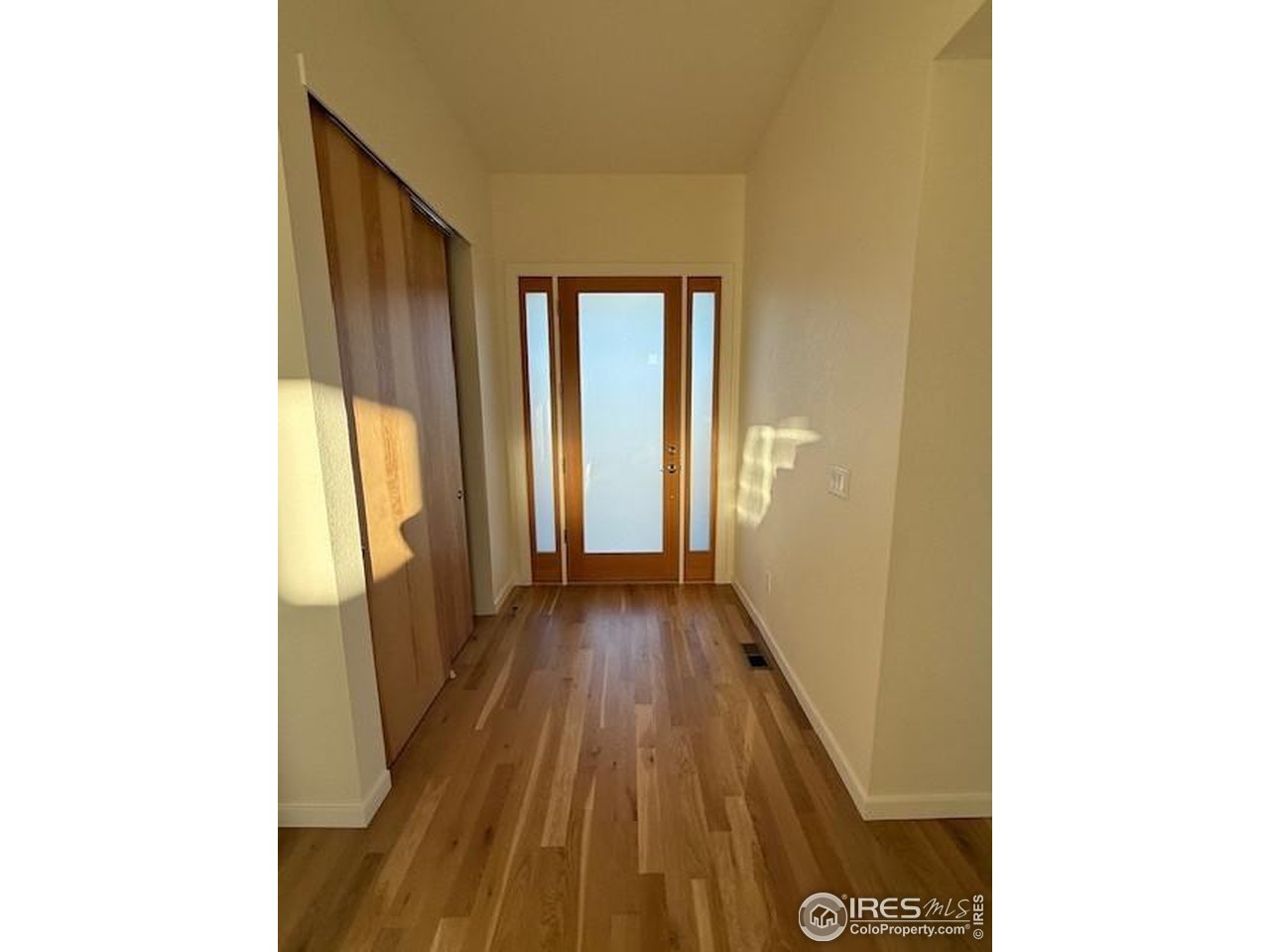 607 Mountain Drive Longmont, CO 80503 - Photo 6 of 18 a view of a hallway with wooden floor