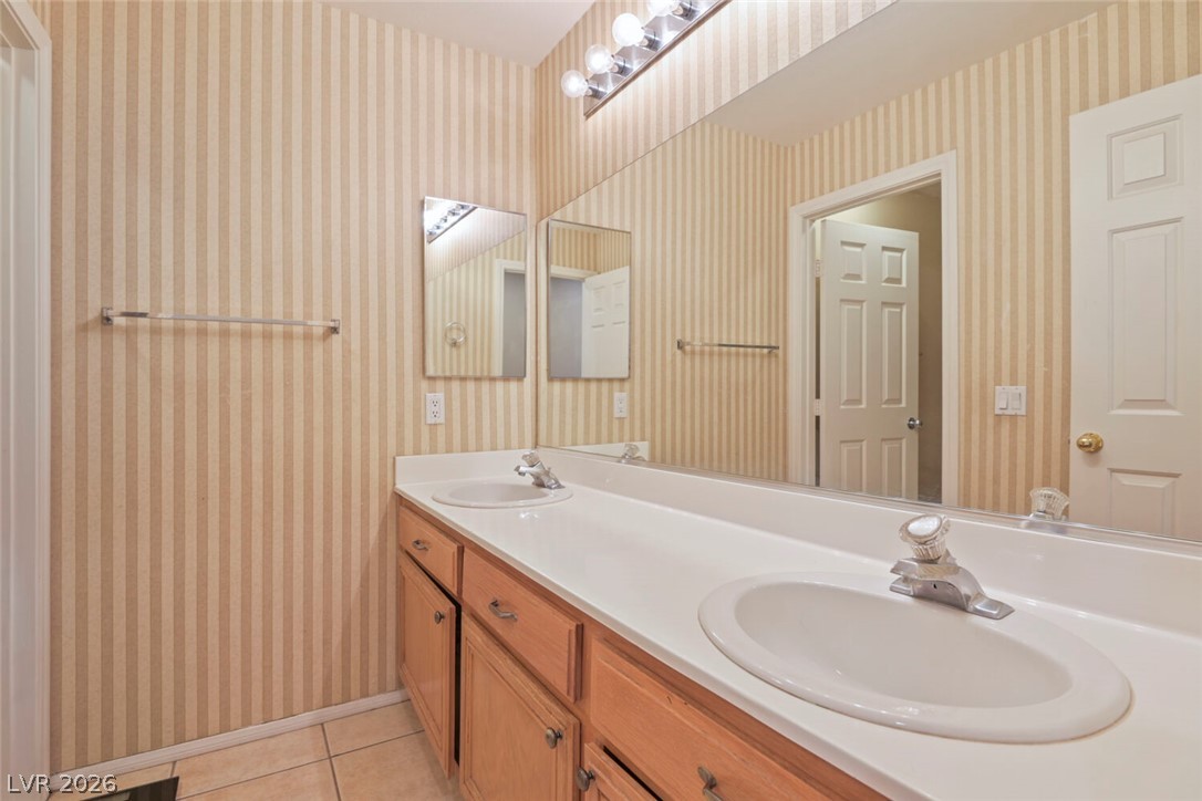 2356 Tilden Way Henderson, NV 89074 - Photo 23 of 30 Double vanity sinks and an expansive mirror elevate daily routines in this well-appointed bathroom.