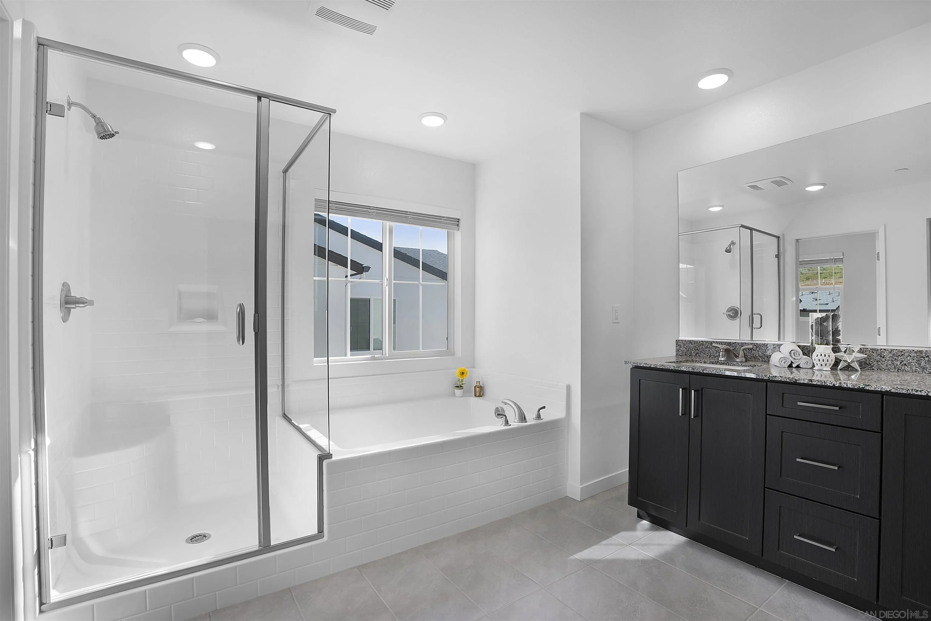223 Foliage Place Fallbrook, CA 92028 - Photo 14 of 46 a bathroom with a tub a sink shower and mirror