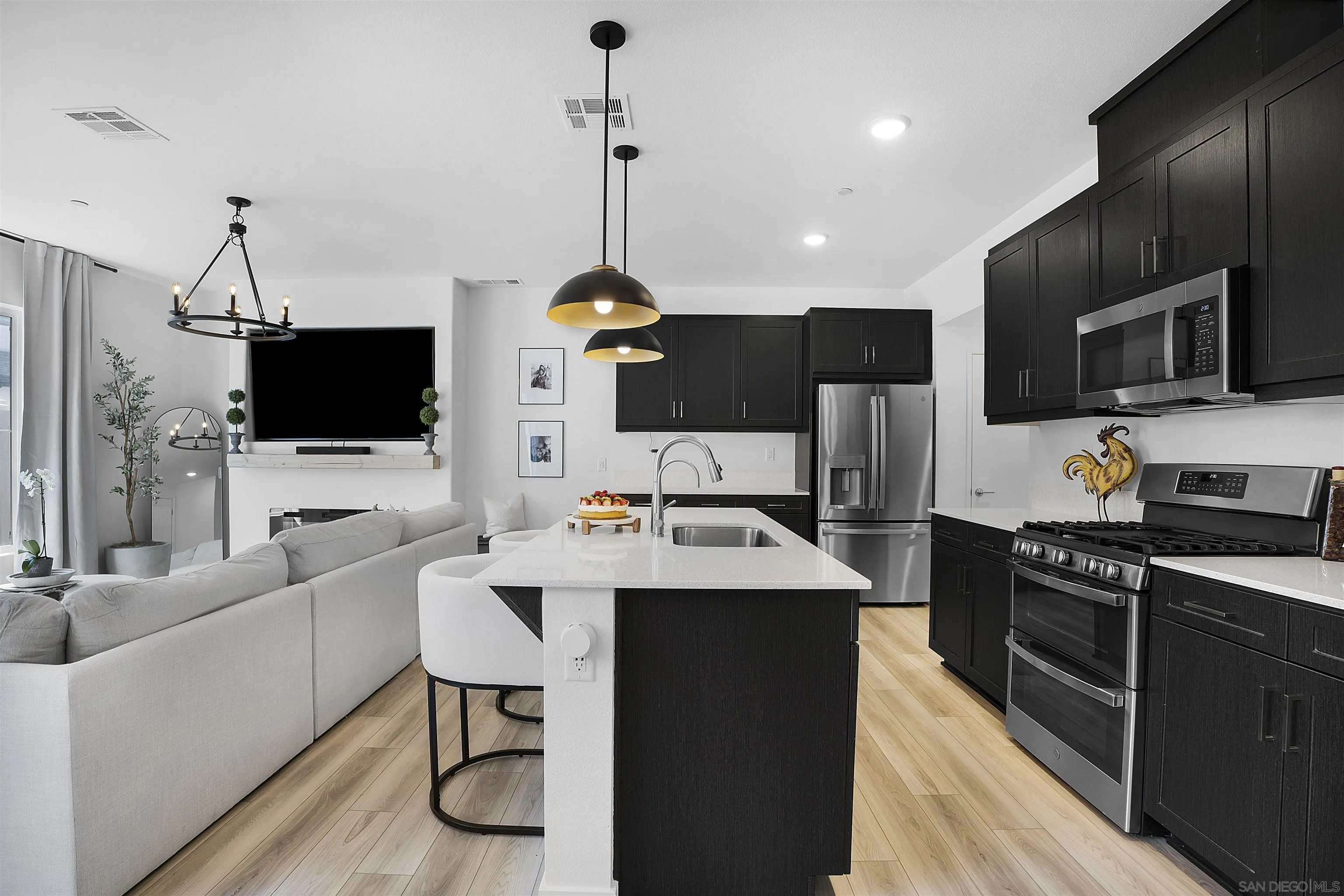 223 Foliage Place Fallbrook, CA 92028 - Photo 6 of 46 a kitchen with stainless steel appliances a stove a sink dishwasher a oven with a dining table and chairs