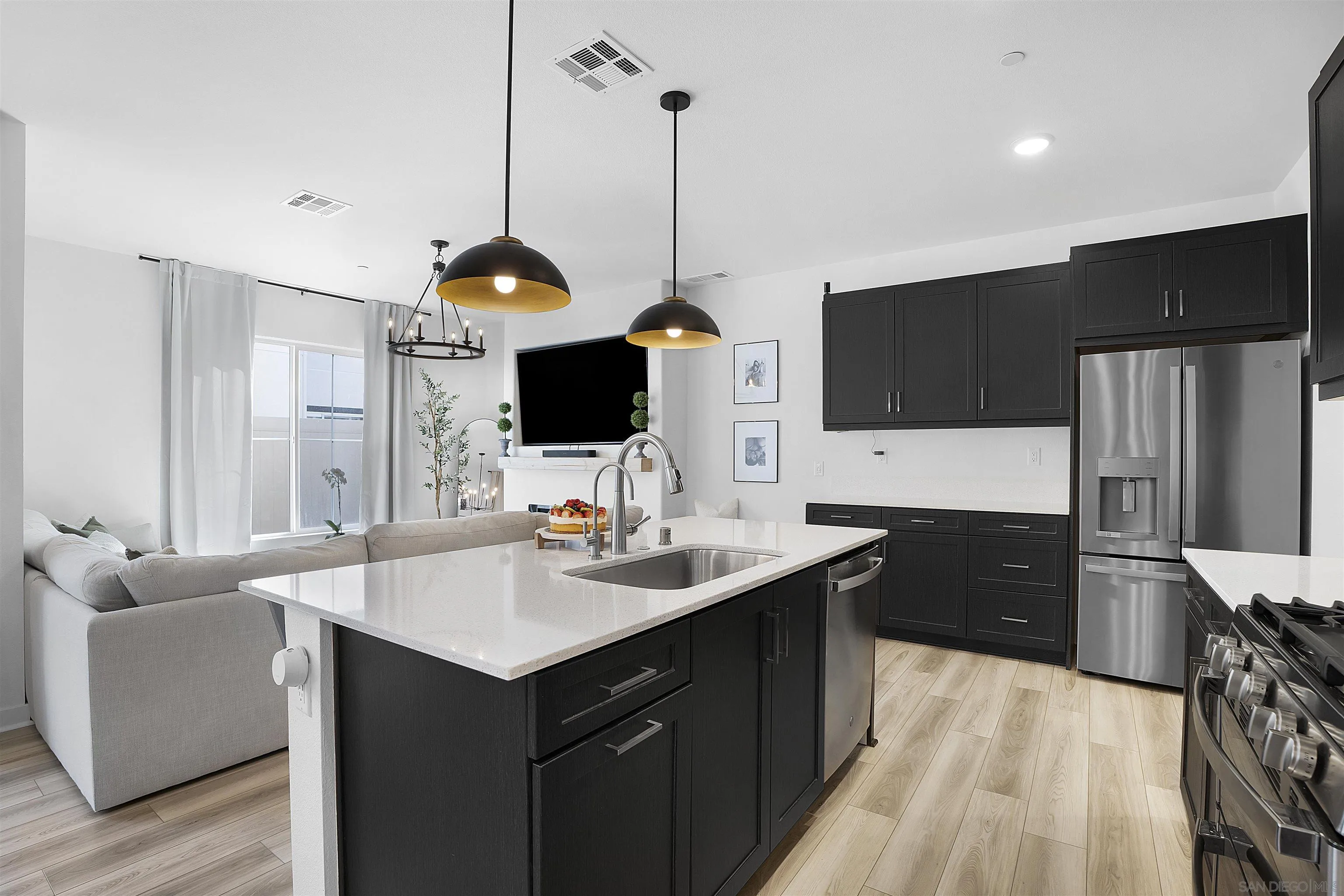 223 Foliage Place Fallbrook, CA 92028 - Photo 7 of 46 a kitchen with a sink refrigerator and microwave