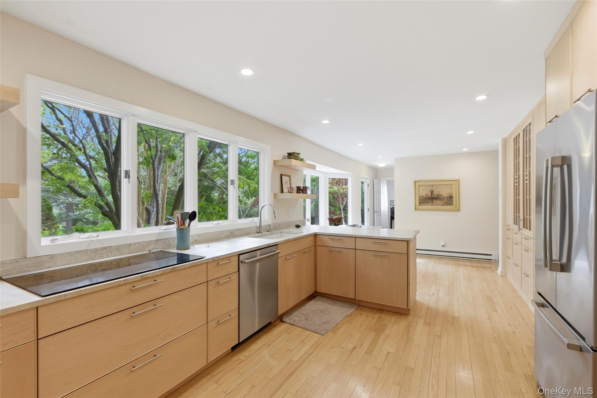 7 Gun Path Setauket, NY 11733 - Photo 12 of 34 a large white kitchen with granite countertop a large window and a sink