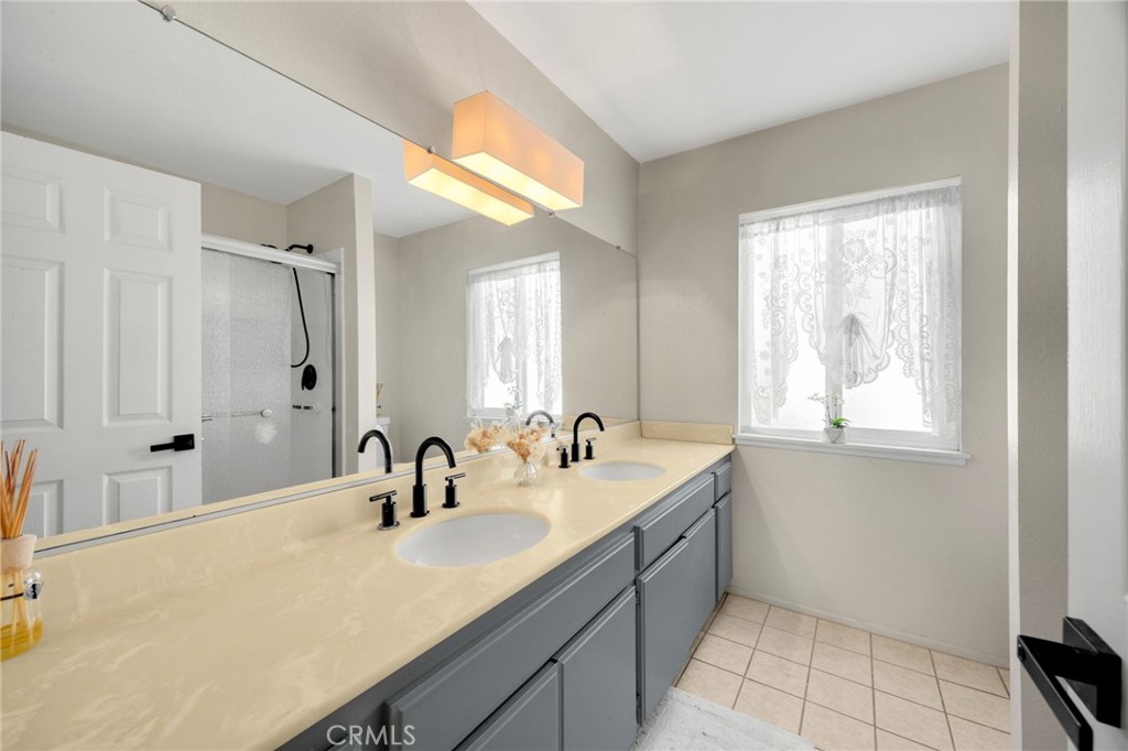 536 Silver Canyon Way Brea, CA 92821 - Photo 24 of 40 a bathroom with a granite countertop sink and a mirror