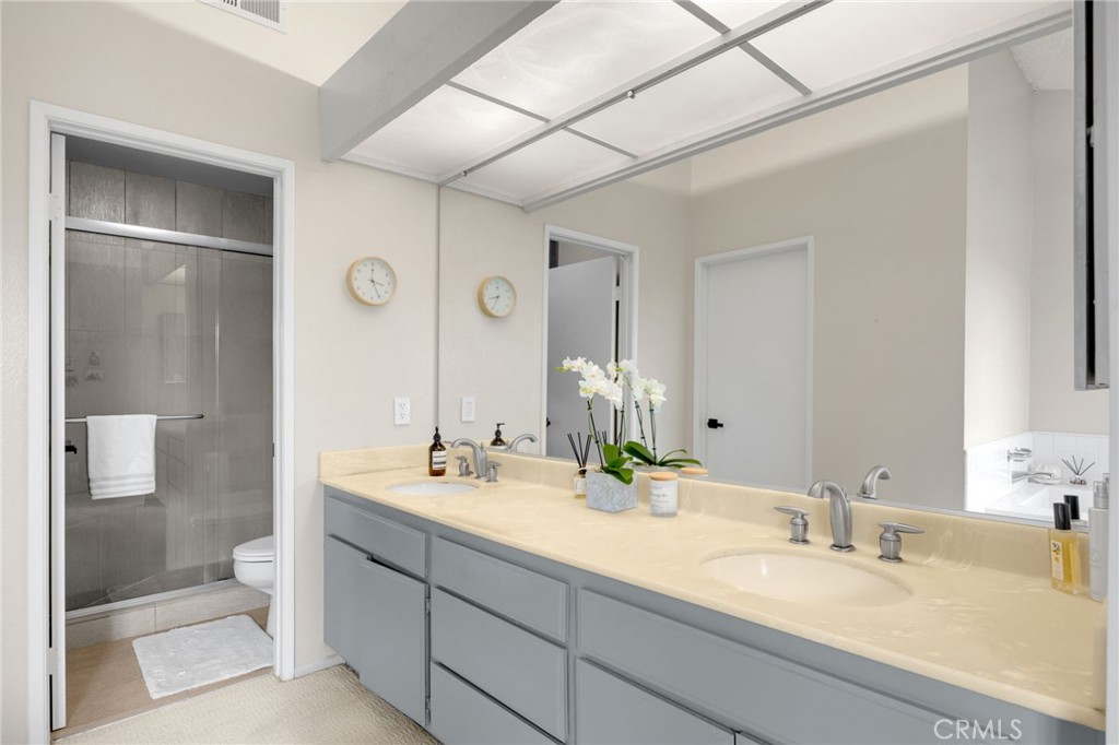 536 Silver Canyon Way Brea, CA 92821 - Photo 32 of 40 a bathroom with a double vanity sink mirror and shower