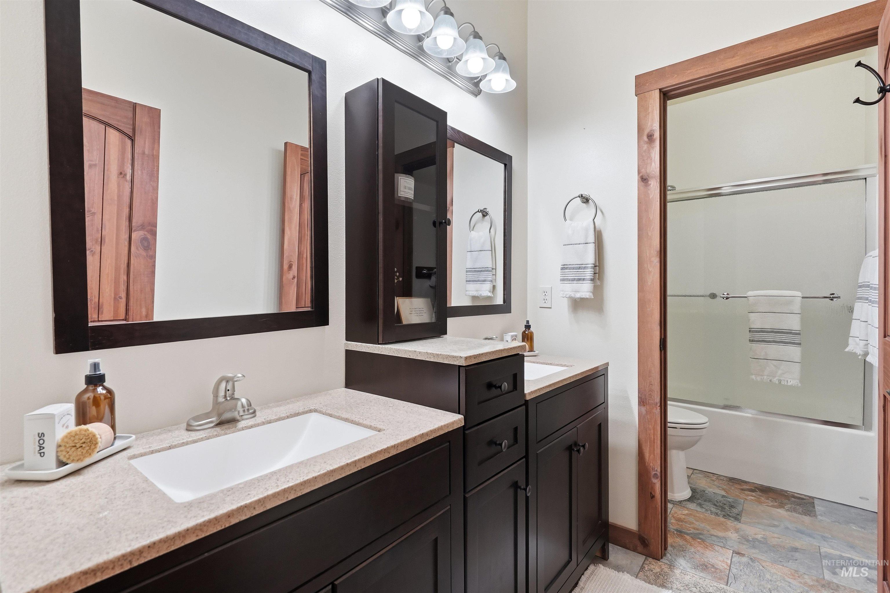 3645 Butte Road Emmett, ID 83617 - Photo 26 of 39 Dual vanity with integrated sinks and dark wood-finish cabinetry