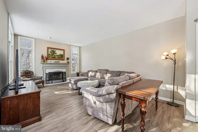 a view of a dining room with furniture large windows and wooden floor