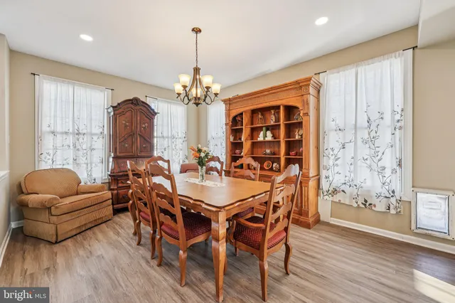 a kitchen with stainless steel appliances granite countertop a stove a sink and white cabinets