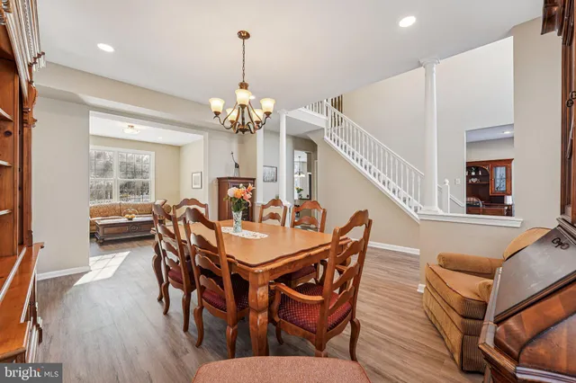 a kitchen with stainless steel appliances granite countertop white cabinets a refrigerator a stove a sink and a oven with white cabinets