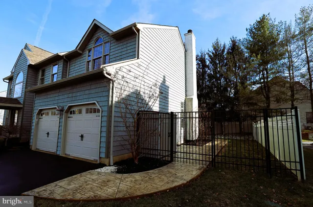 a view of a house with a wooden fence
