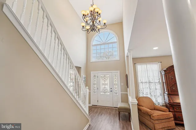 a bed sitting in a spacious bedroom next to a window