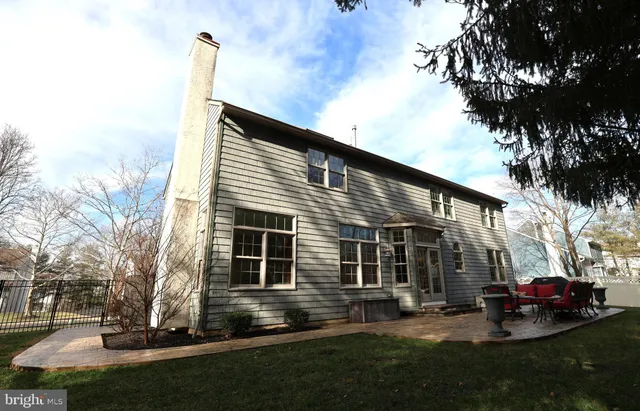 a view of a house with a yard and sitting area