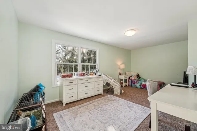 a picture of a room with a white wall and a white refrigerator