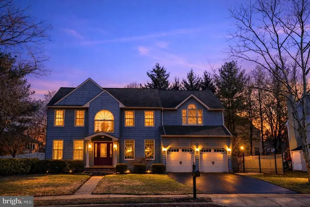 a front view of a house with a yard covered in snow
