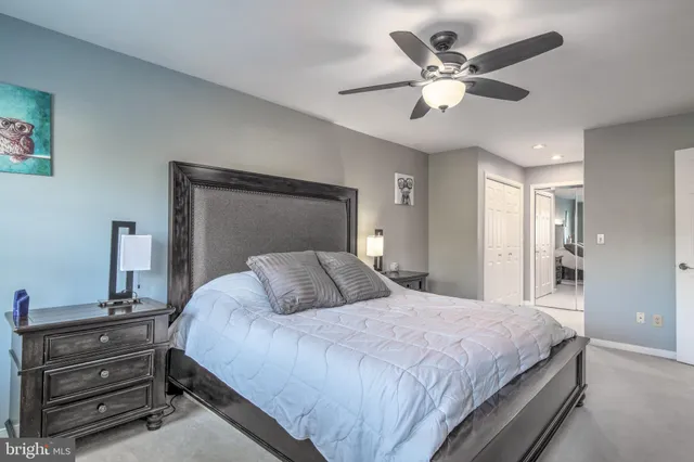 a bedroom with a bed and ceiling fan