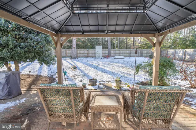 a patio with a yard table and chairs