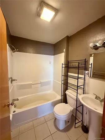 a bathroom with a toilet a sink and bathtub